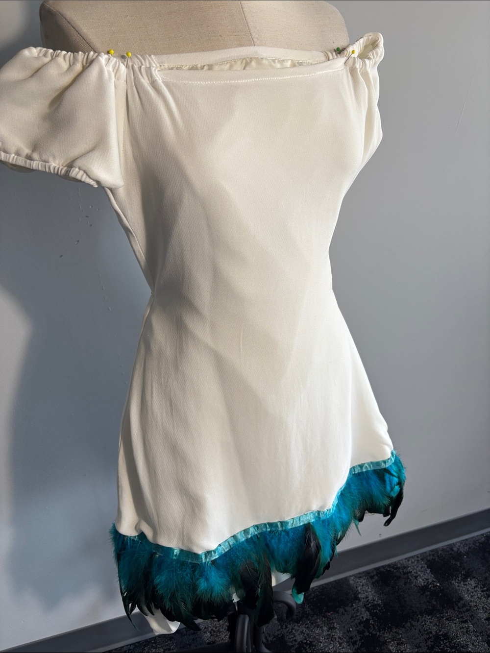 Off-Shoulder Cream Tunic with Teal Feather Trim